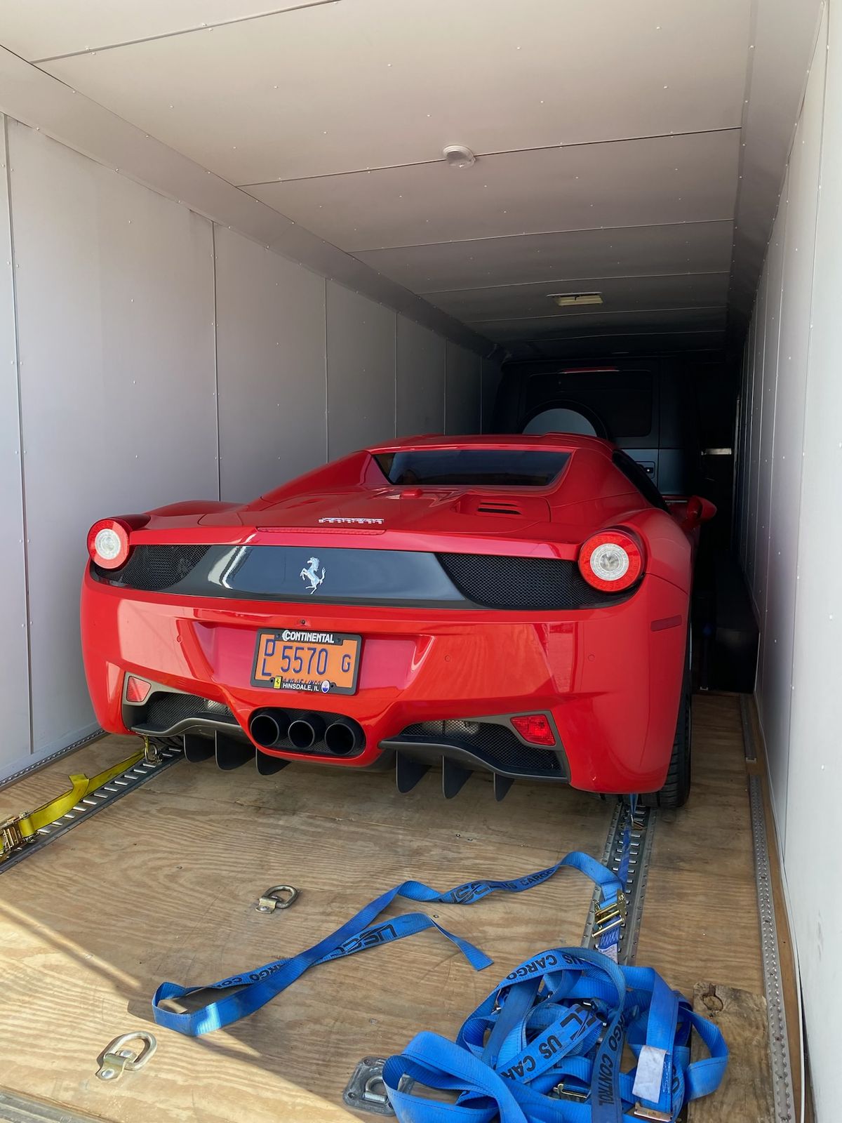 Ferrari 458 secured inside an enclosed trailer