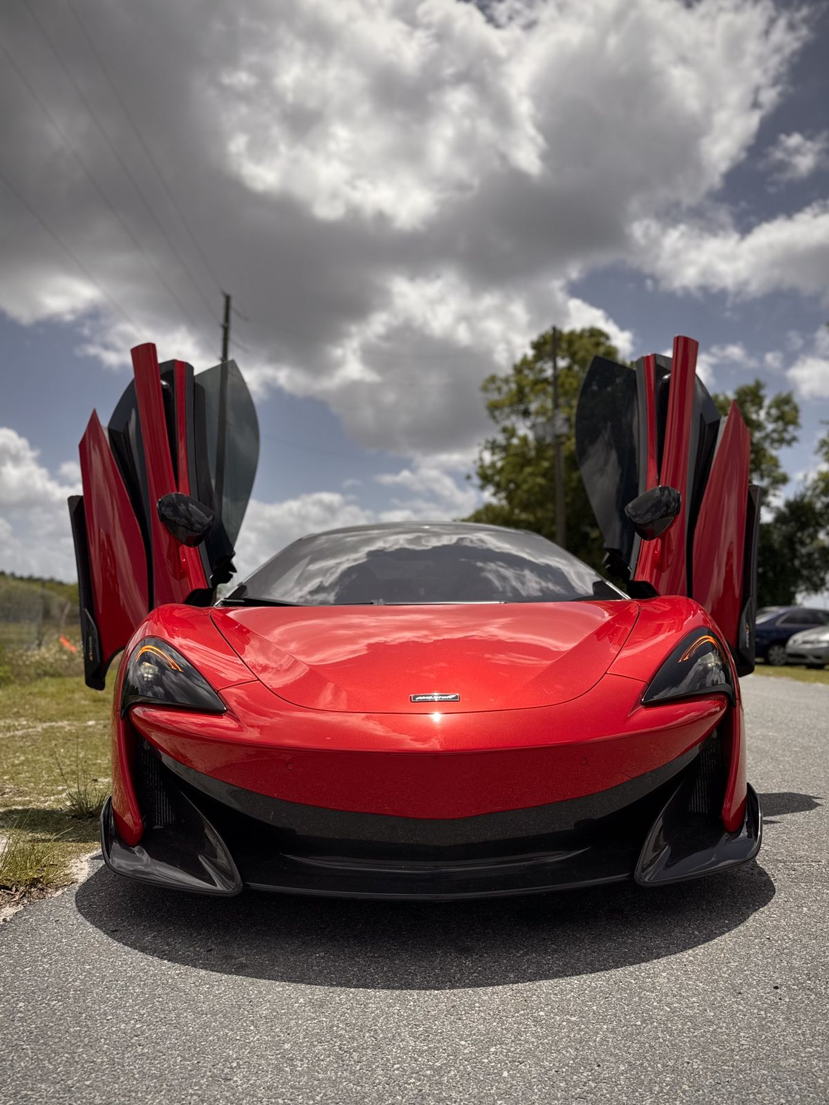 Red McLaren 600LT with doors open
