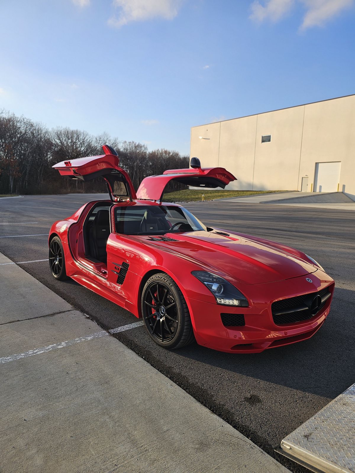 Red Mercedes-Benz SLS AMG with gullwing doors open