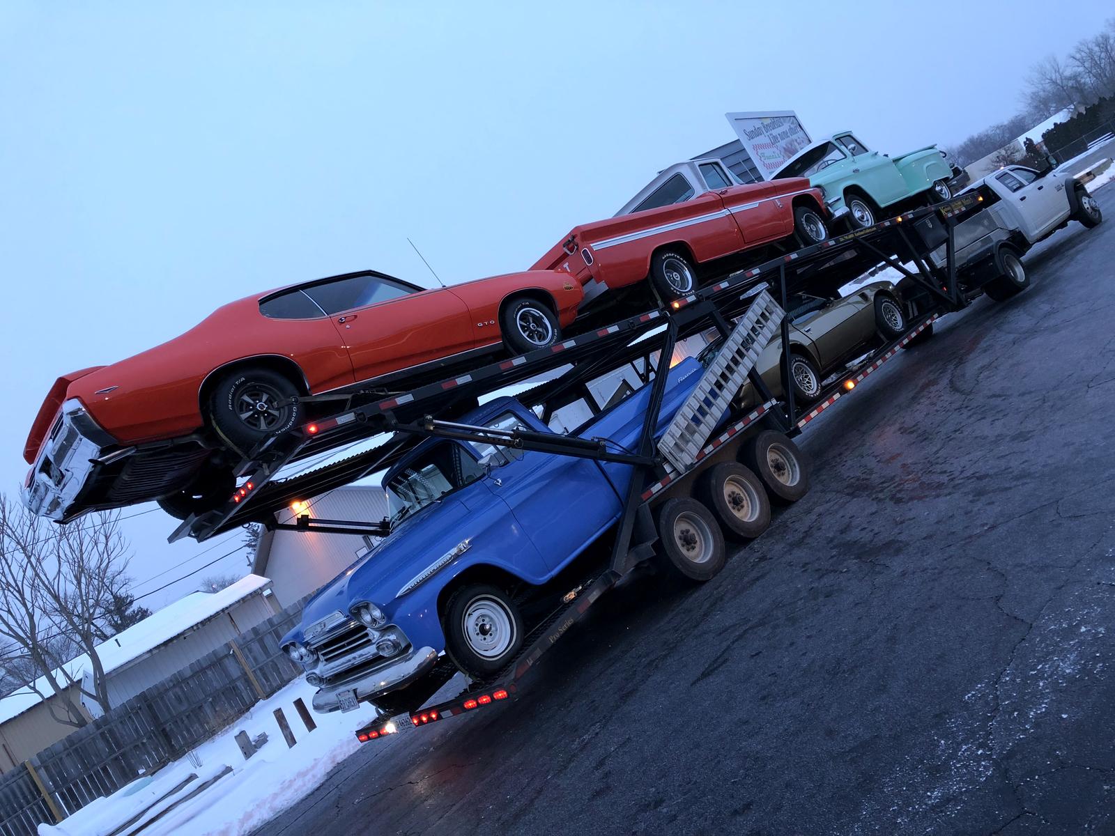 Car hauler fully loaded with classic American cars and trucks